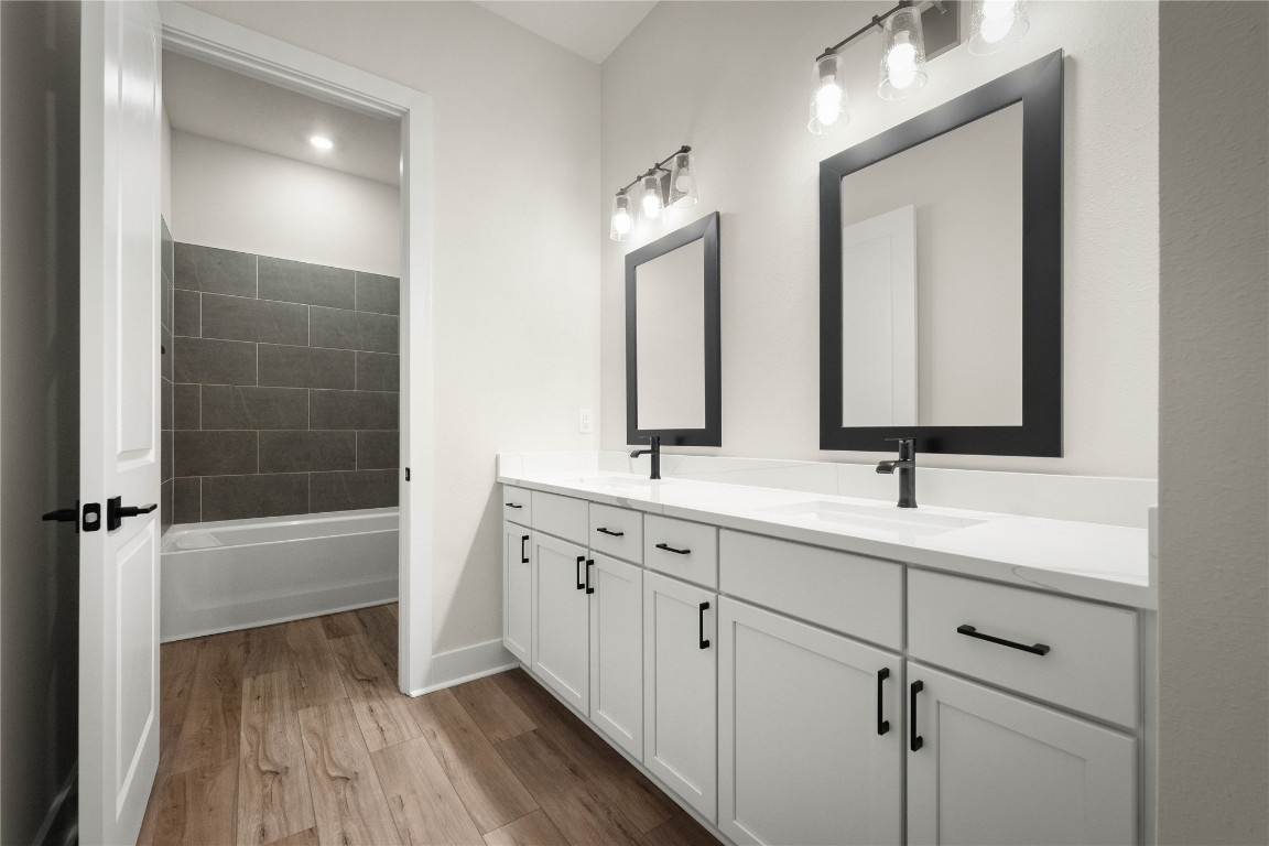 36199 Pitch Lane Hilliard, FL 32046 - Photo 10 of 40 a bathroom with 2 sink tub and a mirror