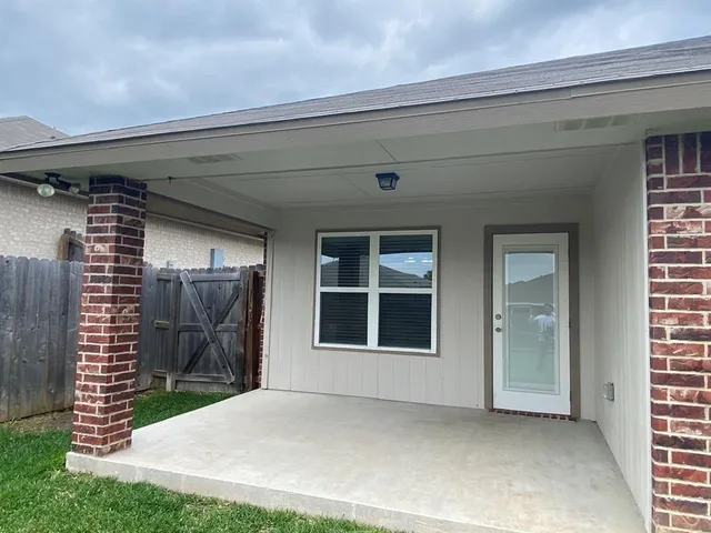 a view of a house with a big yard and large trees
