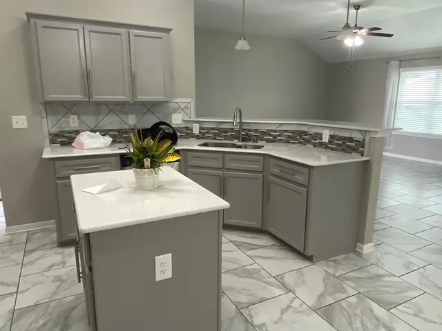 a kitchen with a sink cabinets and appliances