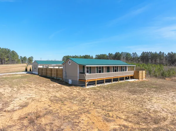 a view of a house with a wooden fence