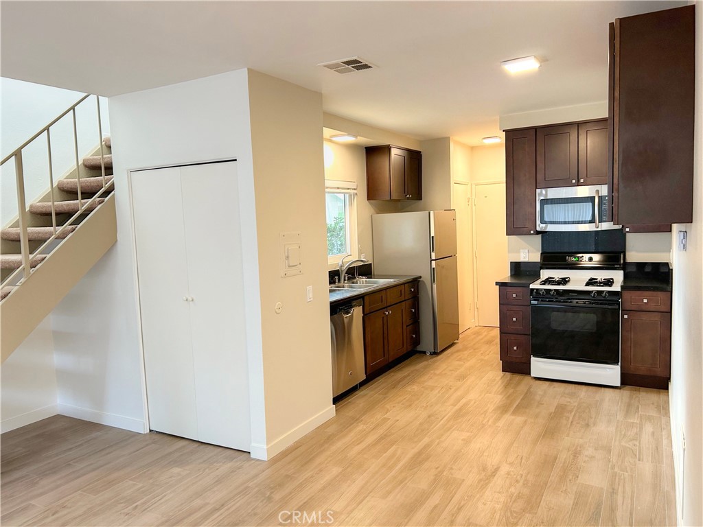 33938 Alcazar Drive, Unit A Dana Point, CA 92629 - Photo 29 of 29 a kitchen with granite countertop a refrigerator and a stove top oven