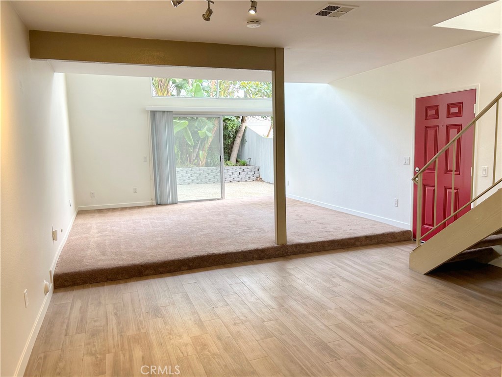 33938 Alcazar Drive, Unit A Dana Point, CA 92629 - Photo 1 of 29 a bedroom with wooden floor and large window