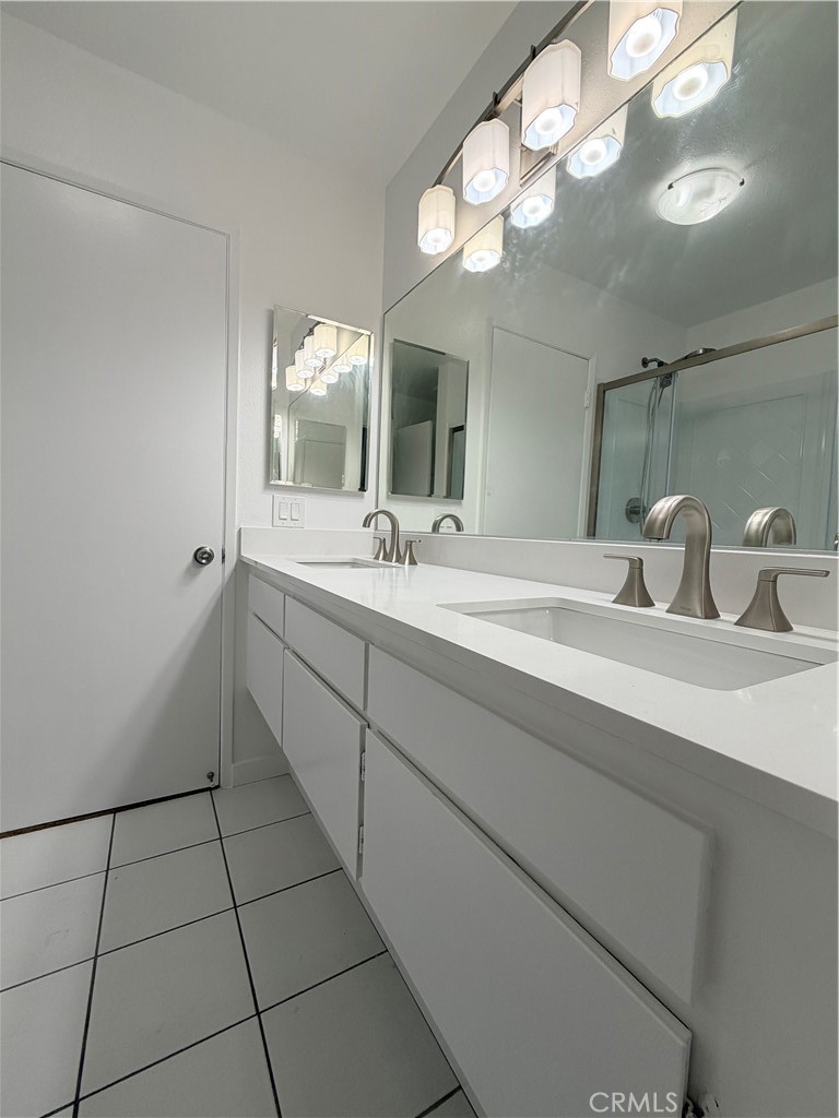 33938 Alcazar Drive, Unit A Dana Point, CA 92629 - Photo 6 of 29 a bathroom with a sink a large mirror and a light fixture