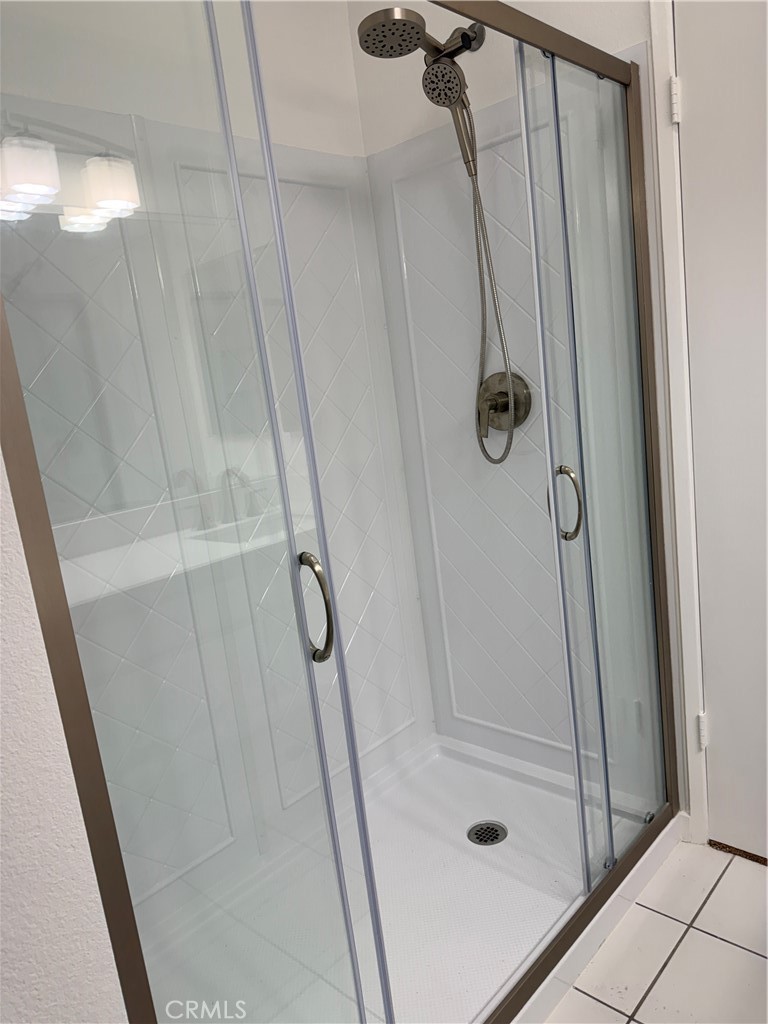 33938 Alcazar Drive, Unit A Dana Point, CA 92629 - Photo 8 of 29 a bathroom with a glass door shower and a sink