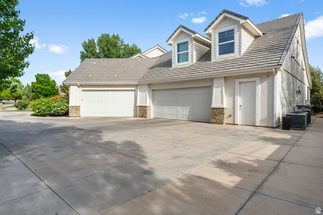 2917 Old Farm Road Washington, UT 84780 - Photo 84 of 105 Cape cod house with concrete driveway, stone siding, and an attached garage
