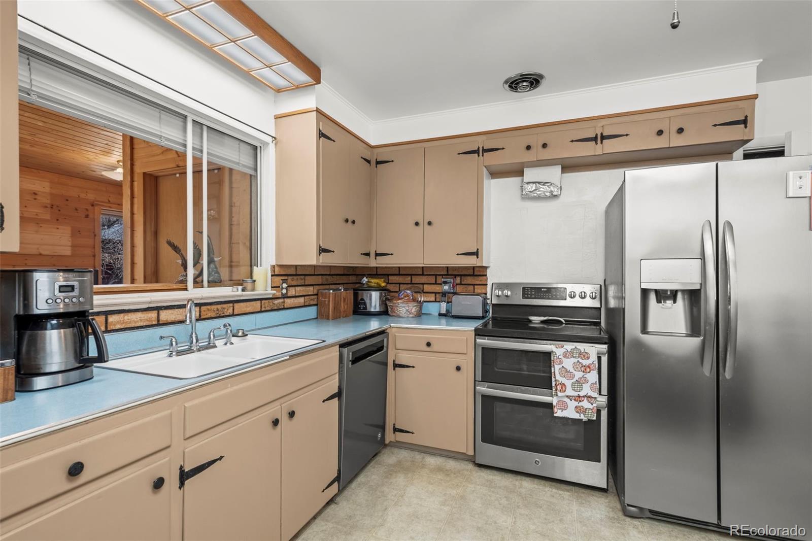 2935 17th Street Boulder, CO 80304 - Photo 11 of 38 a kitchen with stainless steel appliances a sink and a refrigerator