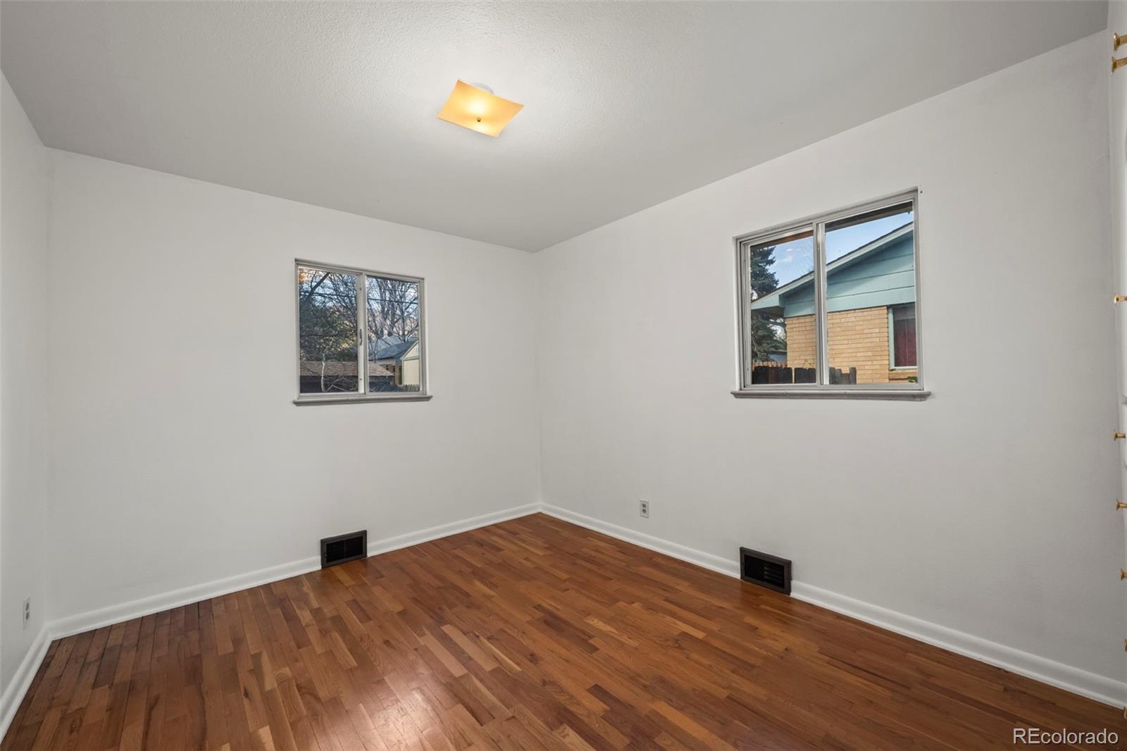 2935 17th Street Boulder, CO 80304 - Photo 17 of 38 a view of an empty room with window and wooden floor