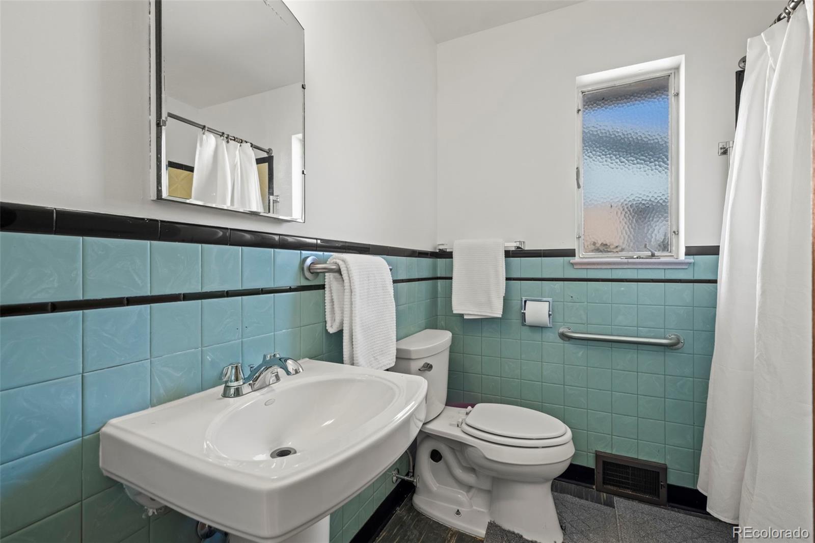2935 17th Street Boulder, CO 80304 - Photo 19 of 38 a bathroom with a sink toilet and mirror