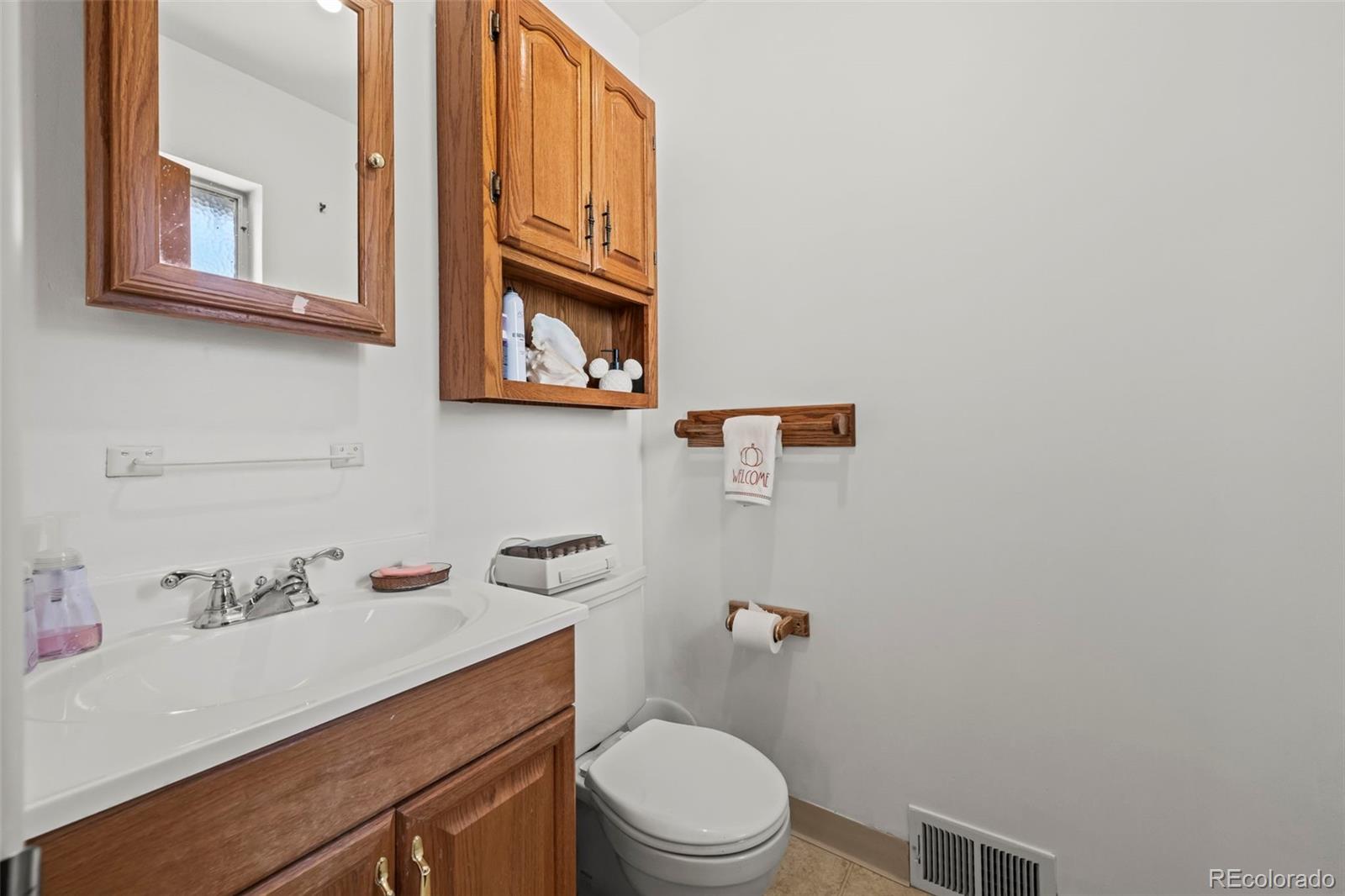 2935 17th Street Boulder, CO 80304 - Photo 20 of 38 a bathroom with a sink a toilet and a mirror