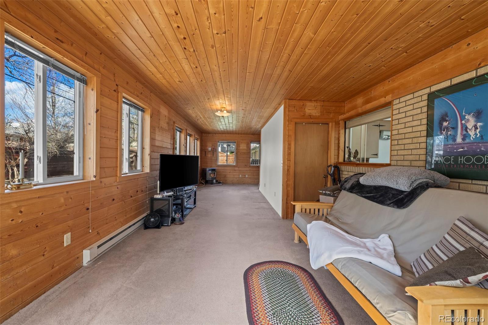 2935 17th Street Boulder, CO 80304 - Photo 22 of 38 a bedroom with furniture and a flat screen tv