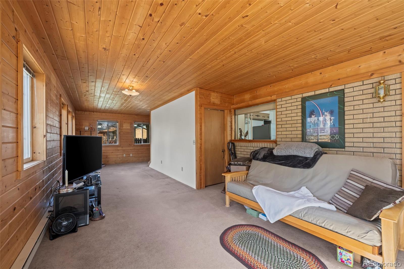 2935 17th Street Boulder, CO 80304 - Photo 23 of 38 a living room with furniture a flat screen tv and a window