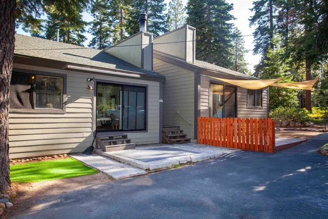 a view of a house with backyard and sitting area