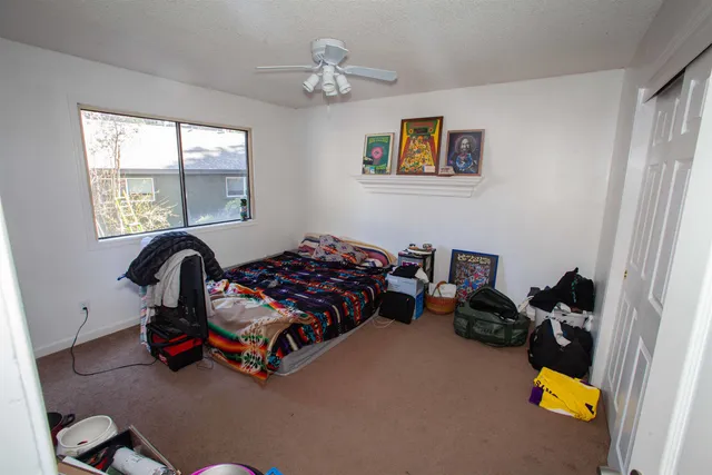 a bedroom with bed and a window