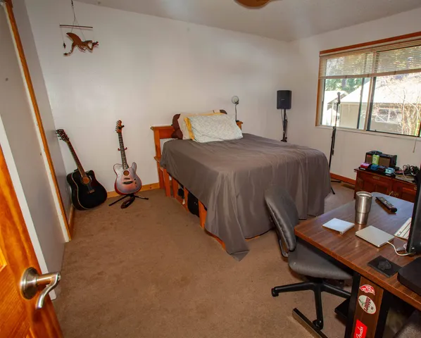 a bedroom with a bed and a desk
