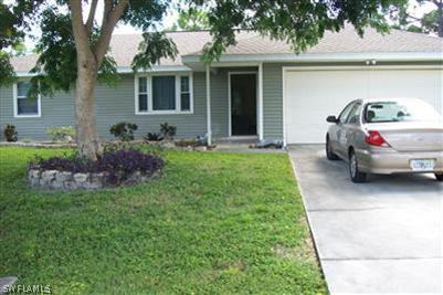 18423 Hawthorne Road Fort Myers, FL 33967 - Photo 1 of 3 a front view of a house with garden