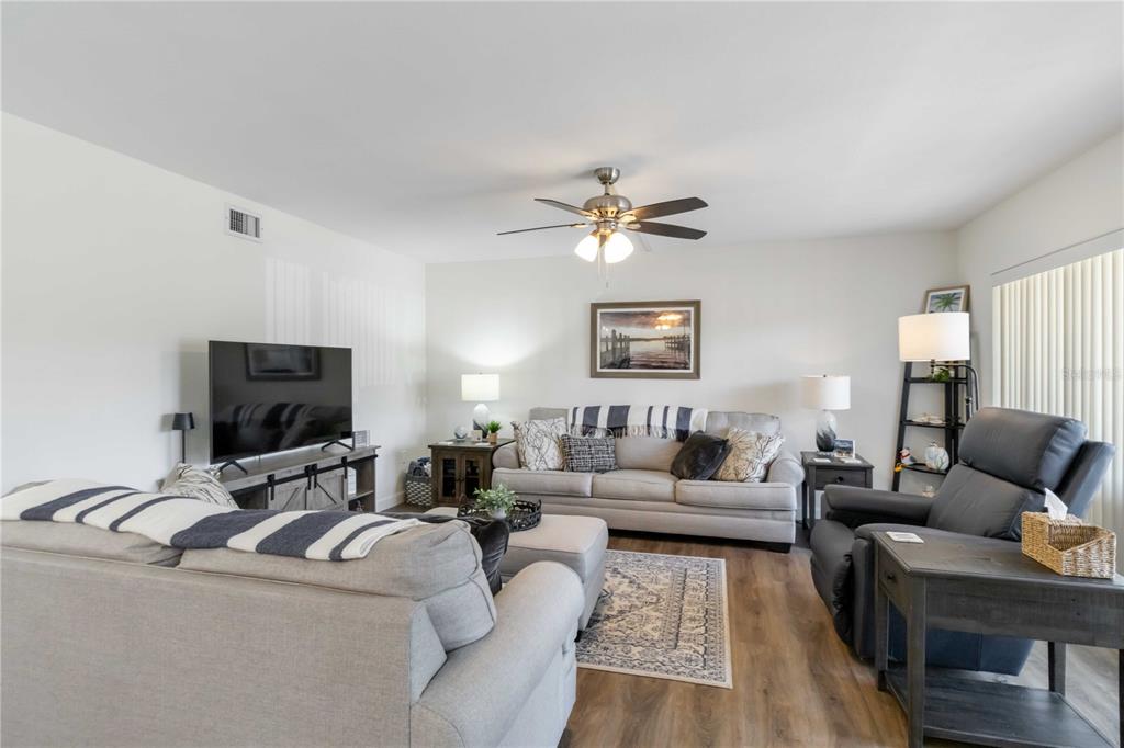 5416 Swift Road, Unit 27 Sarasota, FL 34231 - Photo 12 of 55 a living room with furniture and a flat screen tv