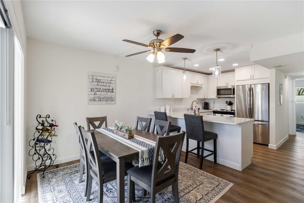 5416 Swift Road, Unit 27 Sarasota, FL 34231 - Photo 13 of 55 a view of a dining room with furniture and wooden floor