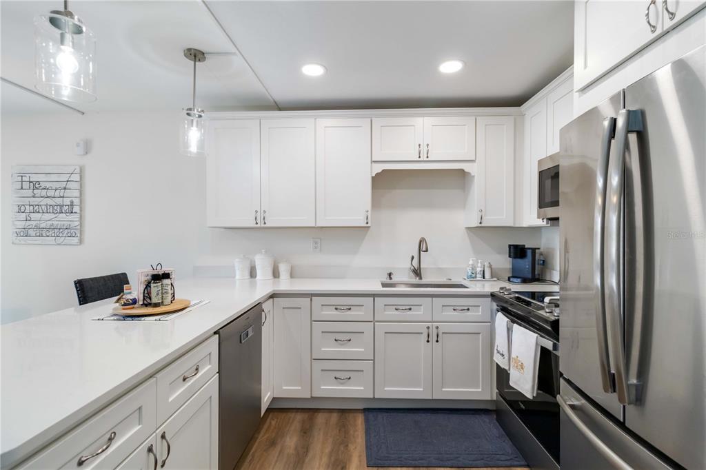 5416 Swift Road, Unit 27 Sarasota, FL 34231 - Photo 17 of 55 a kitchen with a sink stainless steel appliances and cabinets