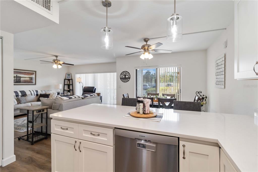 5416 Swift Road, Unit 27 Sarasota, FL 34231 - Photo 18 of 55 a kitchen with a sink a stove and chairs