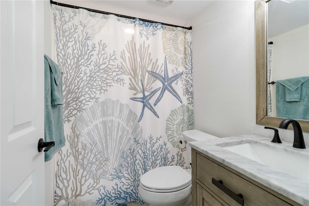 5416 Swift Road, Unit 27 Sarasota, FL 34231 - Photo 25 of 55 a bathroom with a granite countertop sink and a mirror