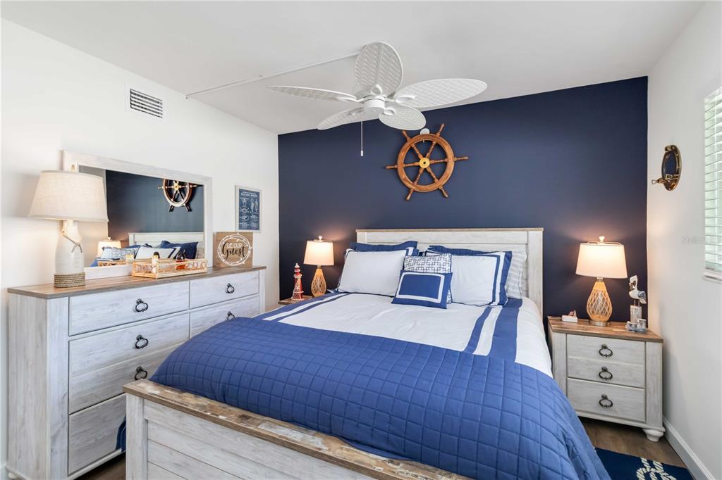 5416 Swift Road, Unit 27 Sarasota, FL 34231 - Photo 27 of 55 a bedroom with a bed and a chandelier