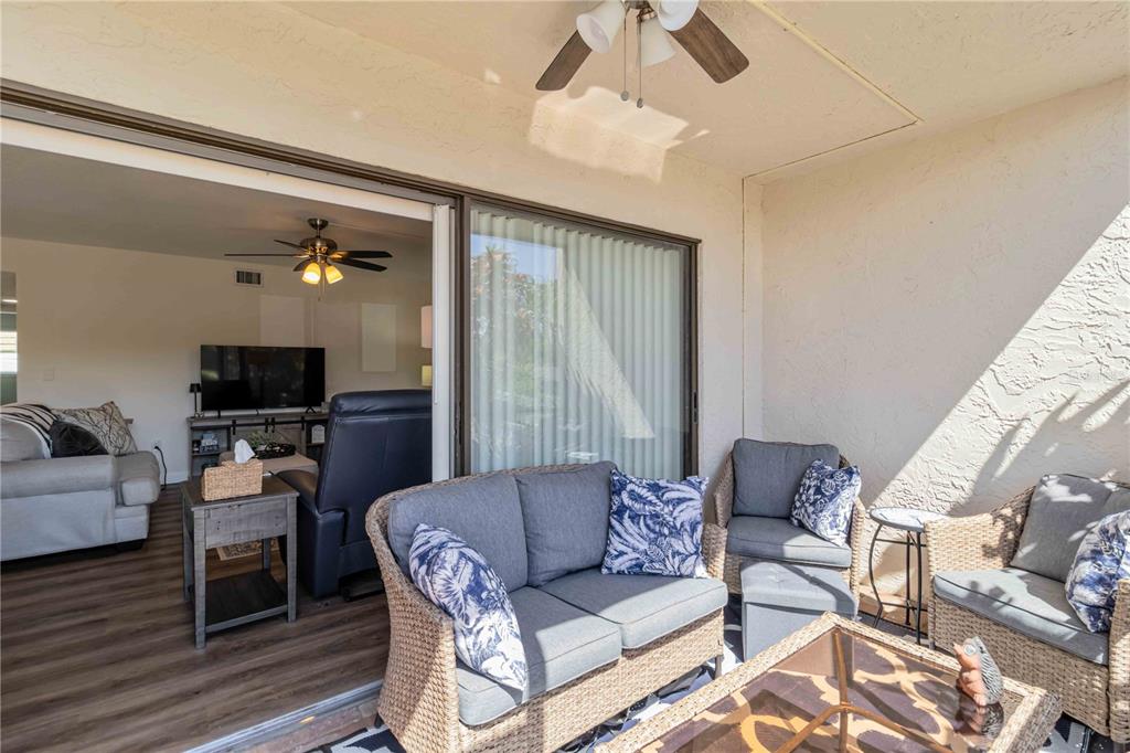 5416 Swift Road, Unit 27 Sarasota, FL 34231 - Photo 4 of 55 a living room with furniture a flat screen tv and a chandelier
