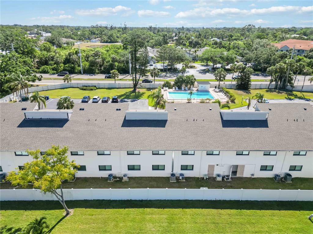 5416 Swift Road, Unit 27 Sarasota, FL 34231 - Photo 48 of 55 a aerial view of a house with a swimming pool a yard and lake view