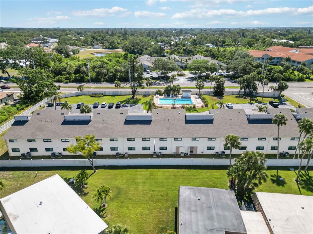 5416 Swift Road, Unit 27 Sarasota, FL 34231 - Photo 49 of 55 an aerial view of a house with a garden and lake view