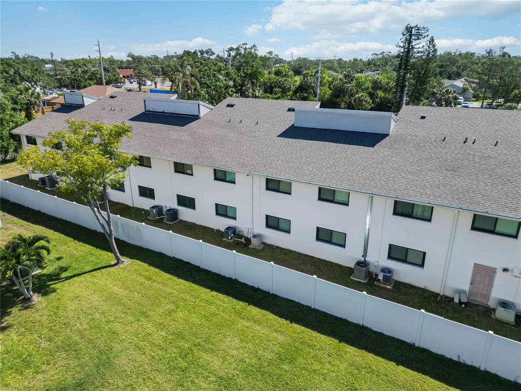 5416 Swift Road, Unit 27 Sarasota, FL 34231 - Photo 53 of 55 aerial view of a house with a yard and a pool