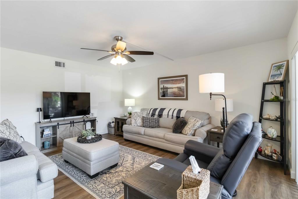 5416 Swift Road, Unit 27 Sarasota, FL 34231 - Photo 9 of 55 a living room with furniture a flat screen tv and a couch