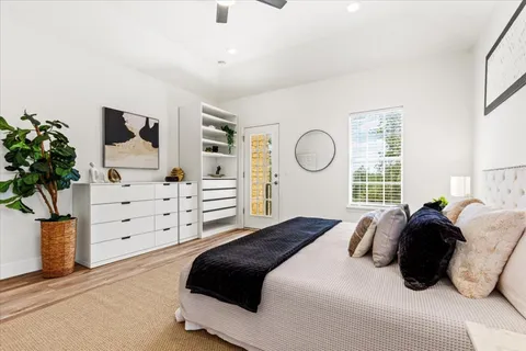 a bedroom with a bed a couch and a chandelier