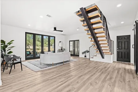 a living room with furniture and a wooden floor