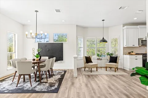 a view of a dining room with furniture window and wooden floor