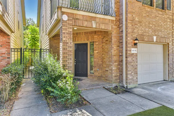 a view of a brick house with plants