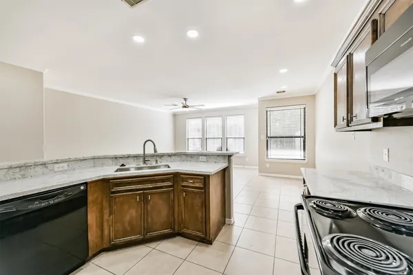 a kitchen with a sink stove top oven and cabinets