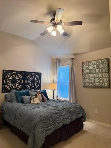 a bedroom with a bed window and cabinet