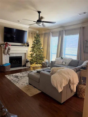 a living room with furniture fireplace and flat screen tv