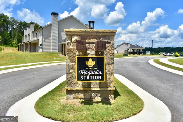 a view of a swimming pool with a yard and plants