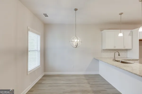 a kitchen with stainless steel appliances granite countertop a sink a stove and a granite counter top