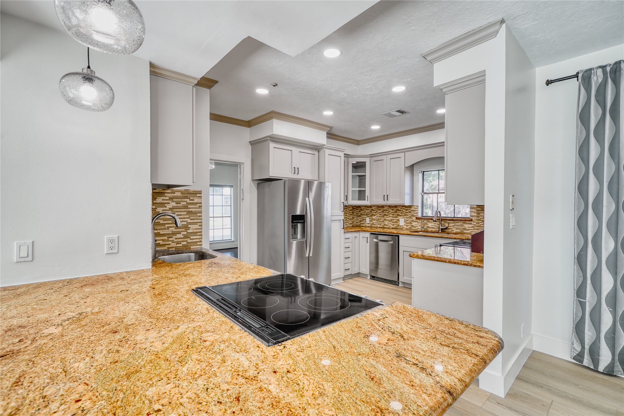 8006 Albin Lane Houston, TX 77071 - Photo 12 of 31 a kitchen with stainless steel appliances kitchen island granite countertop a refrigerator and a stove top oven