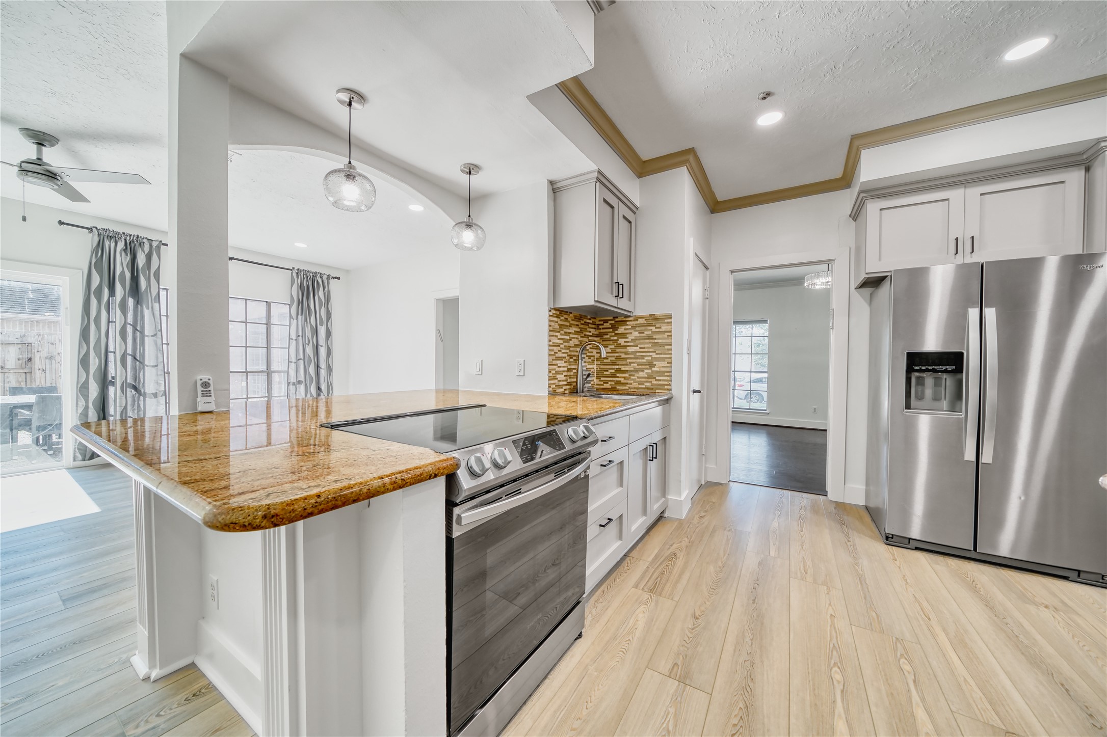 8006 Albin Lane Houston, TX 77071 - Photo 14 of 31 a kitchen with stainless steel appliances granite countertop a refrigerator a sink dishwasher a stove and white countertops with wooden floor