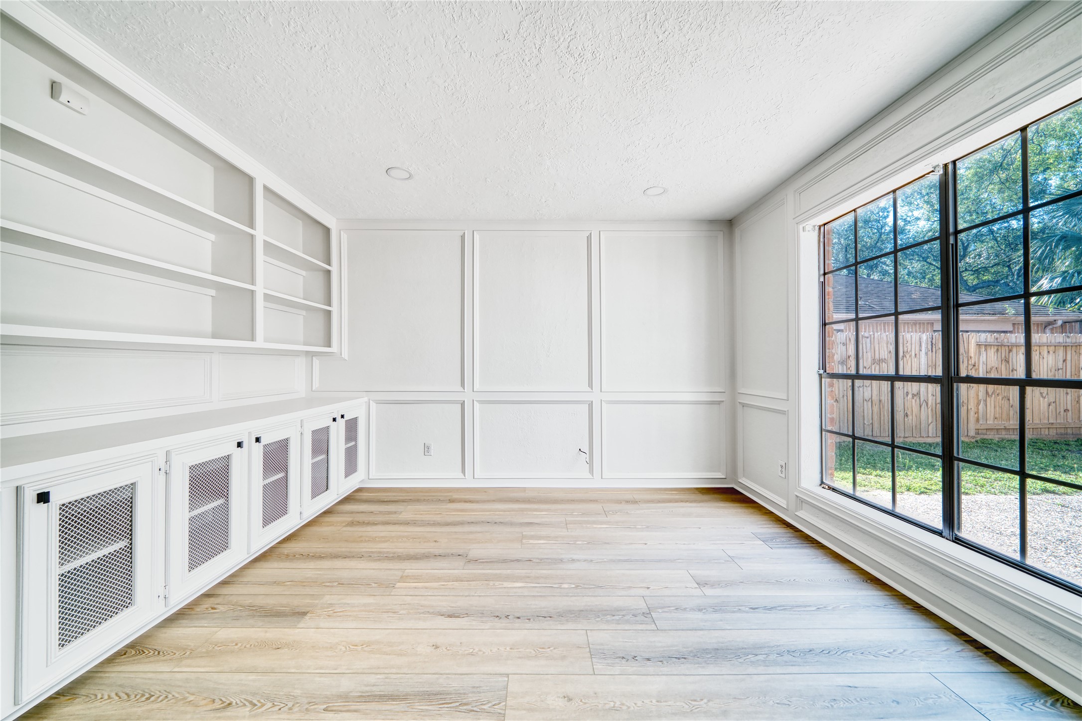 8006 Albin Lane Houston, TX 77071 - Photo 17 of 31 a view of an empty room with wooden floor and windows