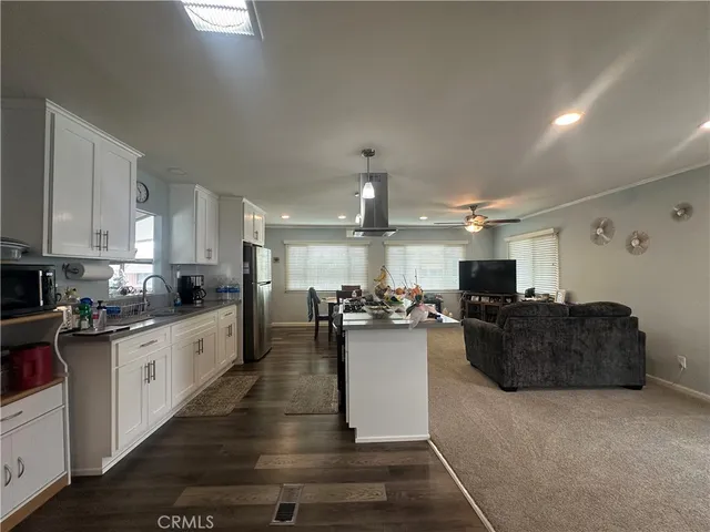 a kitchen with sink refrigerator and cabinets