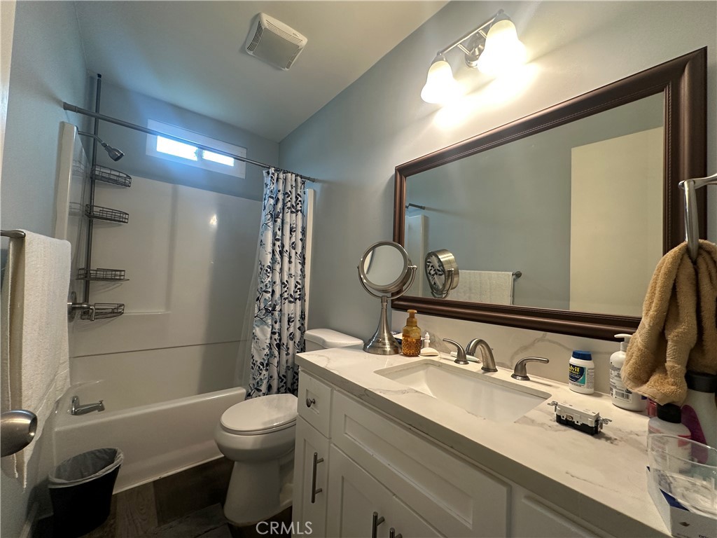 525 North Gilbert Street, Unit 151 Anaheim, CA 92801 - Photo 16 of 18 a bathroom with a sink toilet and shower