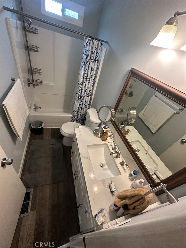 525 North Gilbert Street, Unit 151 Anaheim, CA 92801 - Photo 17 of 18 a bathroom with a sink and mirror with bathtub