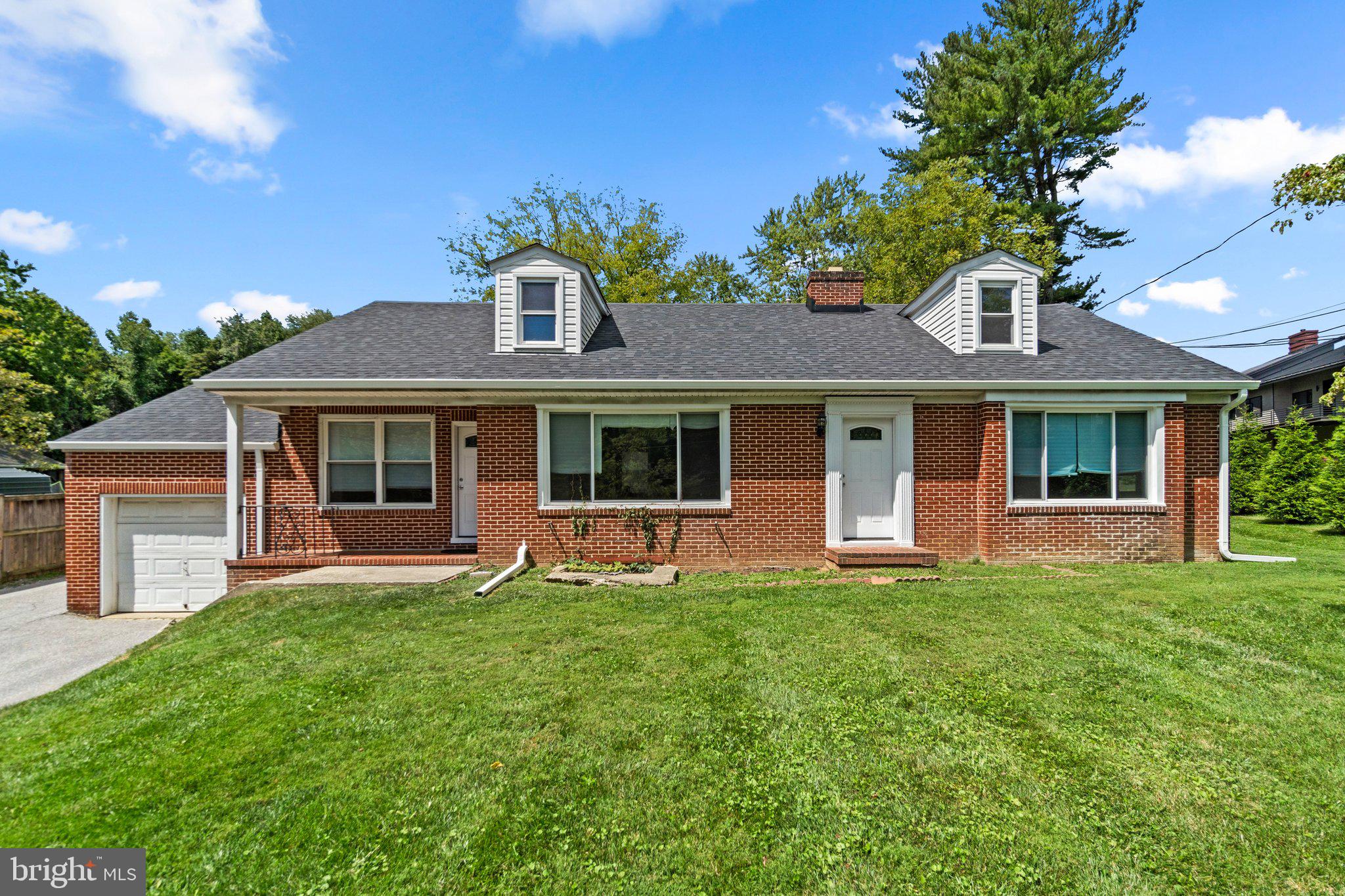 a front view of a house with a garden and porch