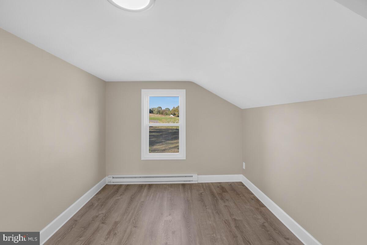 332 Ridge Road, Unit A Westminster, MD 21157 - Photo 12 of 21 an empty room with wooden floor and windows