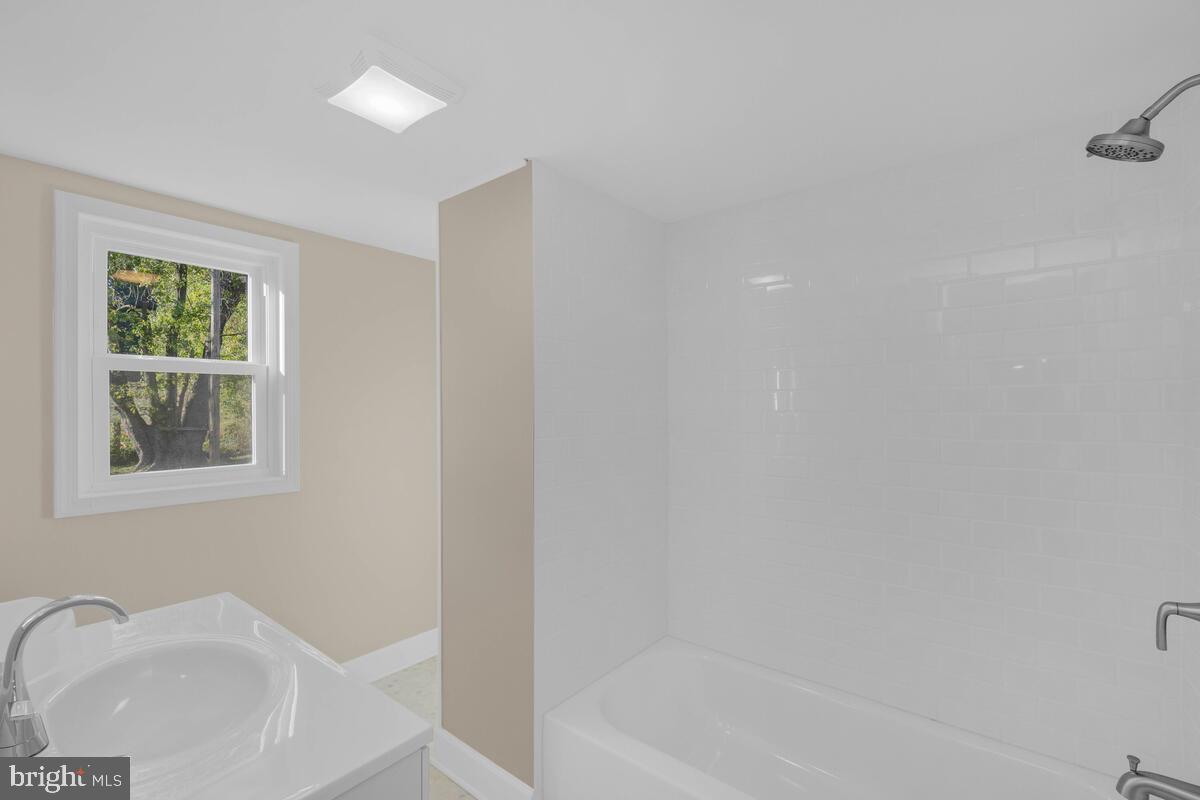 332 Ridge Road, Unit A Westminster, MD 21157 - Photo 16 of 21 a bath room with a sink and a bath tub