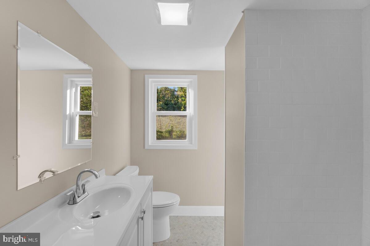 332 Ridge Road, Unit A Westminster, MD 21157 - Photo 17 of 21 a bathroom with a toilet sink and mirror