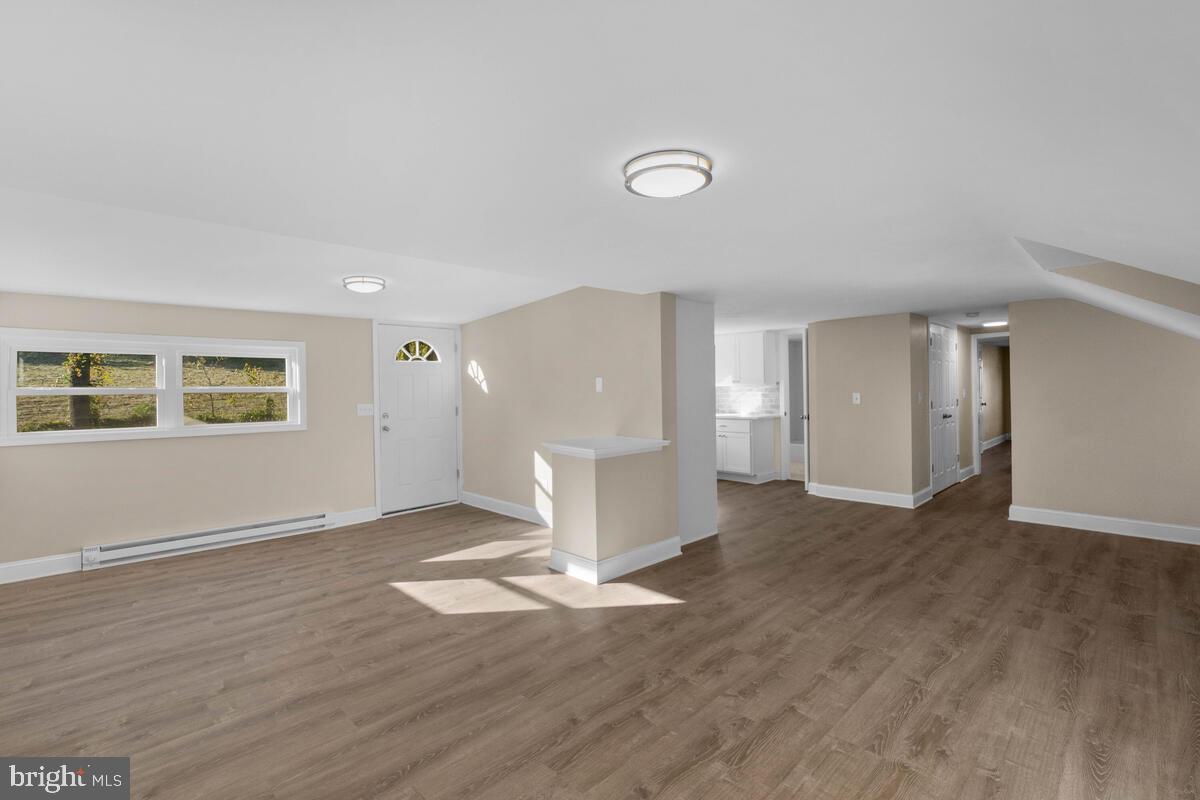 332 Ridge Road, Unit A Westminster, MD 21157 - Photo 2 of 21 an empty room with wooden floor and windows